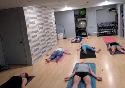 Coach Jennifer's yoga class in studio in resting pose