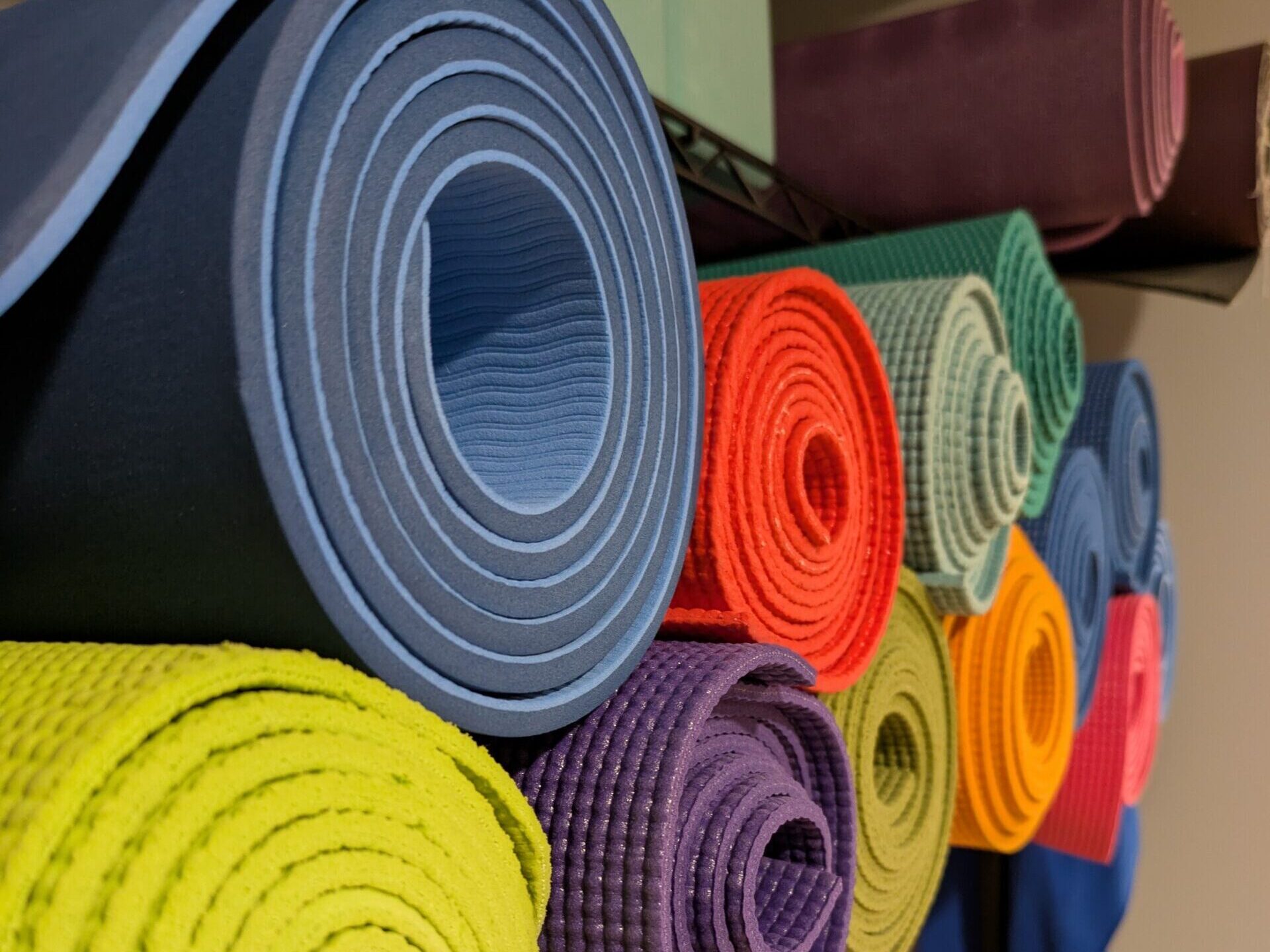 row of colorful yoga mats